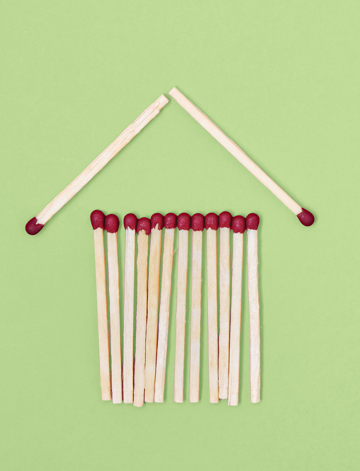 House,Made,From,Matches,On,Red,Background